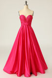 Um vestido de baile longo de fuchsia de linha com ruched