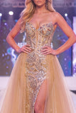 Vestido longo de concurso com espartilho transparente e sereia de champanhe brilhante