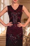 Vestido de lantejoulas pretas douradas com decote em V e franjas
