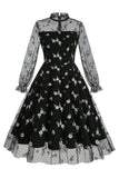 Um vestido vintage preto de pescoço alto de linha com renda